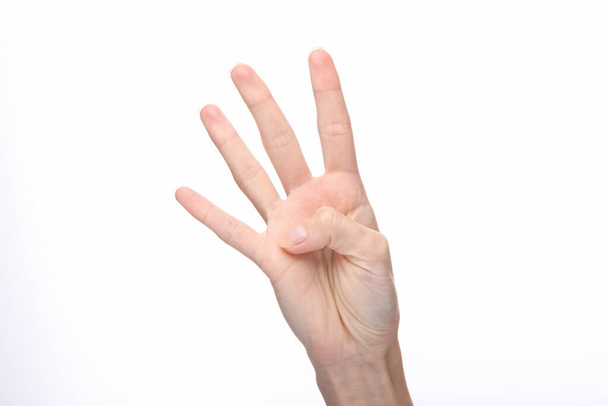 Female hand shows four fingers isolated on white background. - Valokuva, kuva