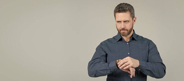 Man face portrait, banner with copy space. Checking his watch. Bearded man look at wristwatch. Time checking. Deadline date. Being punctual - Photo, Image