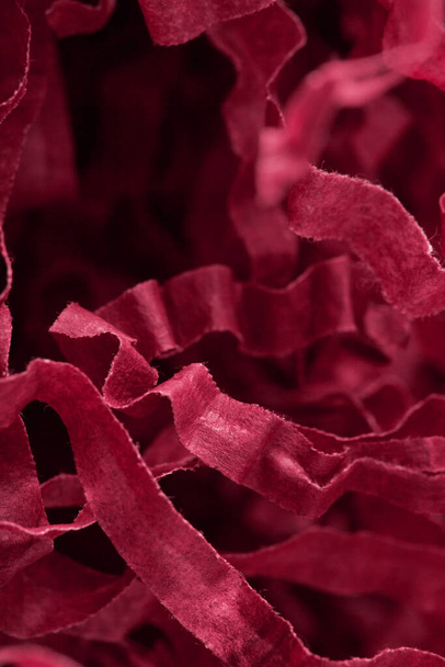 Red twisted tissue paper tapes. Futuristic abstract background in viva magenta color of the year 2023. - Foto, immagini