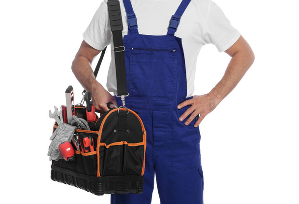 Professional plumber with tool bag on white background, closeup - Φωτογραφία, εικόνα