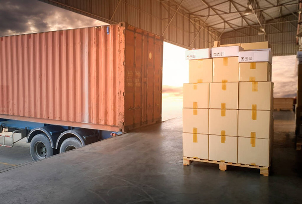 Skrzynki opakowaniowe Ułożone na paletach Wating to Loading into Cargo Container. Pudełka kartonowe. Dostawa ciężarówek. Dostawy towarów w łańcuchu dostaw. Dystrybucja Dostawy Magazyn Logistyka. - Zdjęcie, obraz