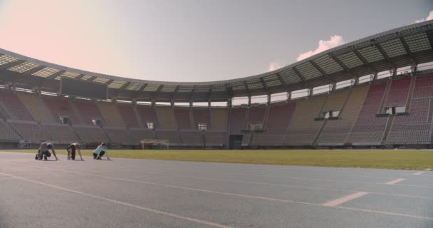 Young people compete on the running track at a stadium - Footage, Video