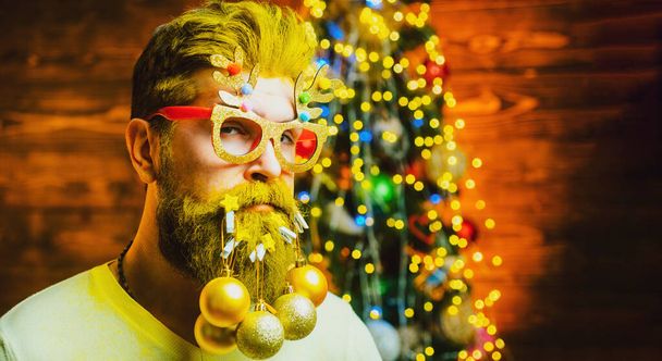 Merry Christmas and happy New Year. Hipster Santa man with tlong beard, x-mas decorations - Photo, Image