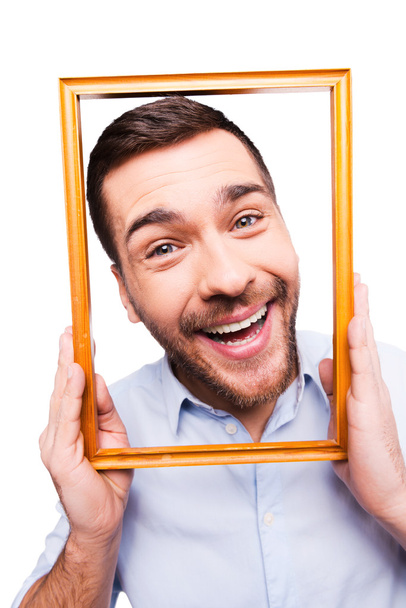 Handsome man holding picture frame - Photo, image