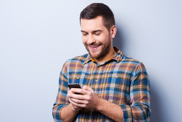 Man in shirt holding mobile phone - Photo, image