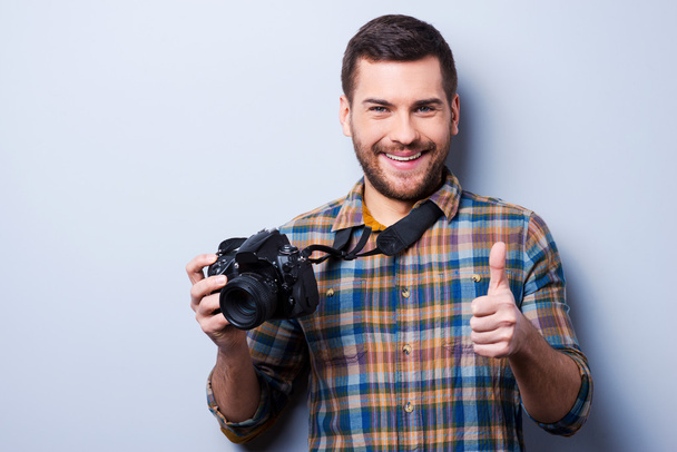 Man holding camera and showing thumb up - Photo, Image