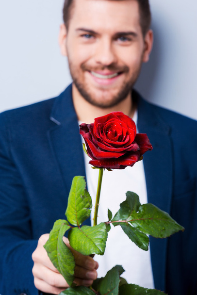 Man giving  flower to you - Фото, изображение