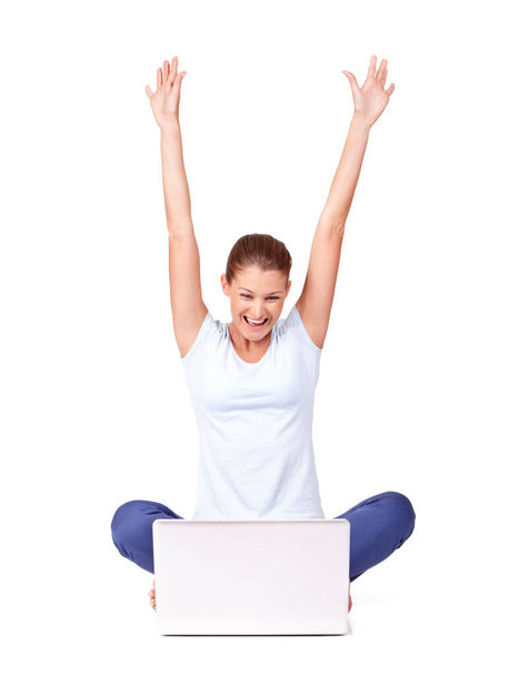 Celebrations. A young woman looking at her laptop screen and celebrating while isolated on white - Фото, зображення