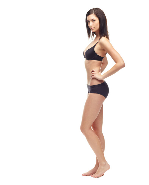 She takes care of herself - Fit Healthy. A slim young woman in her underwear isolated on a white background - Foto, Imagen