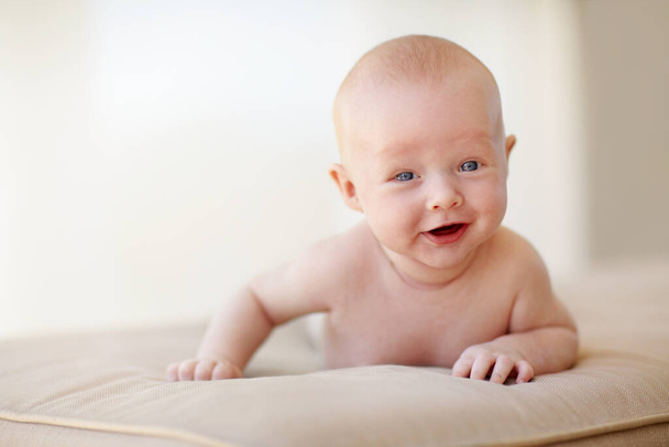 I like you alot. Portrait of a cute baby boy lying on his stomach and laughing - Foto, imagen