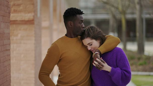 Young interracial couple walking together showing love and affection. arm around partner2 - Photo, Image