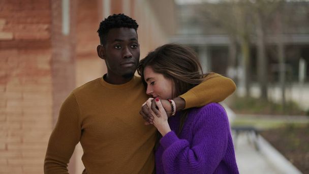 Joven pareja interracial caminando juntos afuera tomados de la mano y besándose. Milenios románticos2 - Foto, imagen