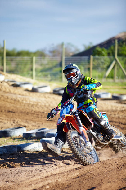 Catching up to the leader. A motocross rider skidding down the track - Foto, Imagem