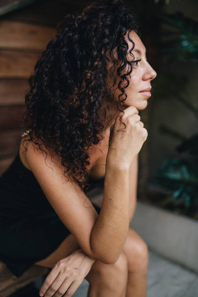 Portrait of a curly woman side view. High quality photo - Zdjęcie, obraz
