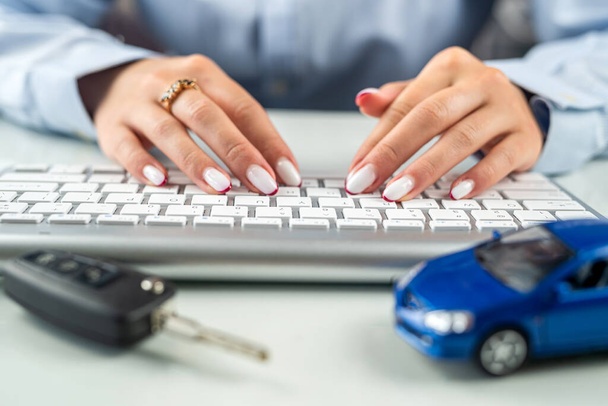 Car dealerships offer car ownership contracts at interest rates in their offices. Desktop. Keyboard with car model - Photo, Image