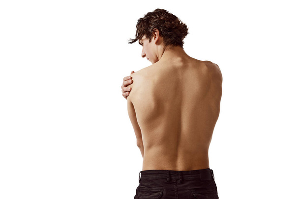 Back view portrait of young shirtless man with muscular body isolated over white background. Relief body. Concept of male beauty, sport, skincare, cosmetology, spa, body care. Copy space for ad - Photo, Image