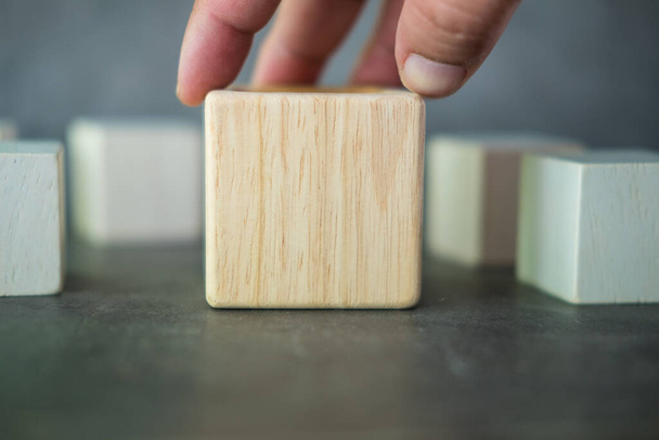 Hand holding big geometric real wooden cube for creative. - Photo, Image