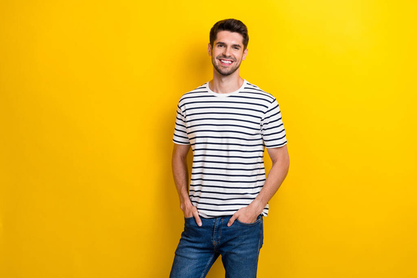 Photo of satisfied glad person beaming smile put hands pockets isolated on yellow color background. - Fotografie, Obrázek