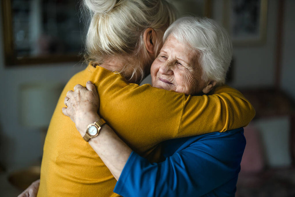 Woman hugging her elderly mother - Fotó, kép