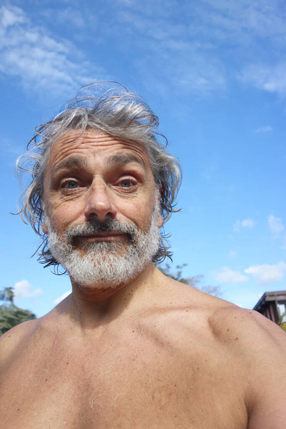 shirtless middle aged man, view from below - Photo, Image