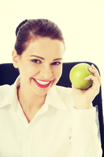 Beautiful business woman holding an apple. - Foto, imagen