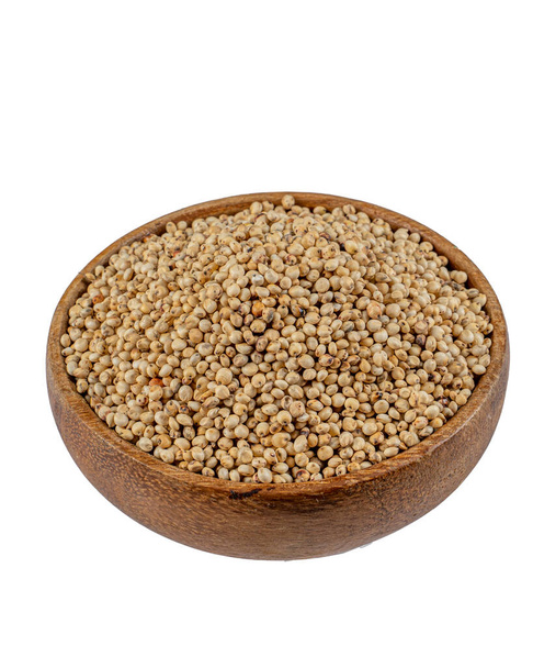 Top kilátás Sorghum gabona kerek tál fehér alapon, egészséges élelmiszer cirok diéta - Fotó, kép