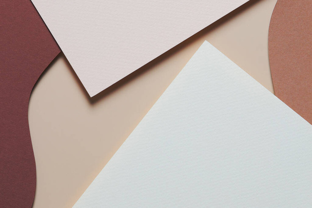 Abstract colored paper texture background. Minimal paper cut style composition with layers of geometric shapes and lines in shades of beige and brown colors. Top view, copy space - Foto, imagen