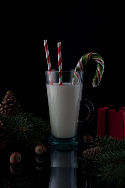 still life Christmas milk on a wooden table with Christmas decorations on a dark background. - Zdjęcie, obraz