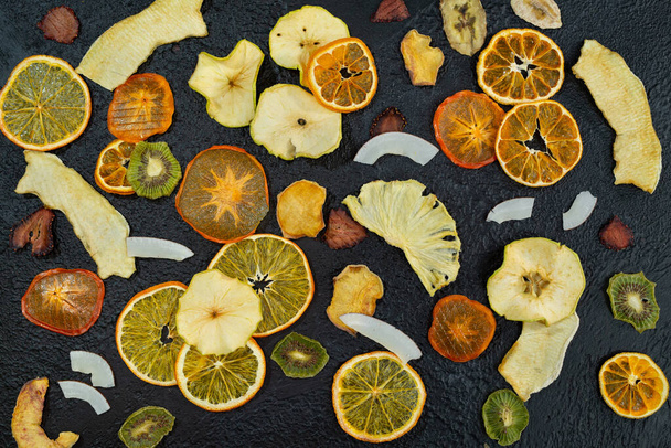 Organic Healthy Assorted Dried Fruit Close-up. Snacks from fraps: apple, pear, orange, banana, persimmon, coconut pineapple strawberry - Fotoğraf, Görsel