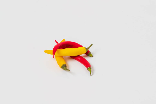Yellow and red hot pepper peppers isolated on white background. - Фото, зображення