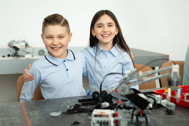 Group of children are playing with robots assembled from plastic parts - Φωτογραφία, εικόνα