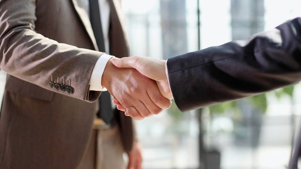 Successful business people handshaking after good deal. - 写真・画像