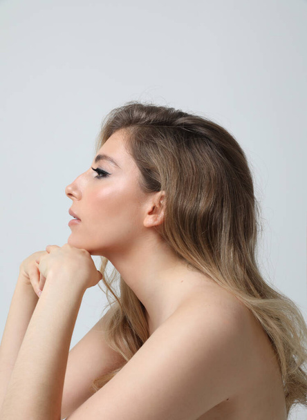 Vertical profile portrait of gorgeous young woman looking away. Mock-up. High quality photo. - Foto, immagini