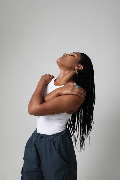 Vertical portrait of African American young woman with long dark braids. Mock-up. High quality photo. - Photo, Image