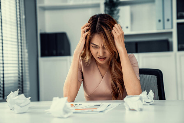 A competent female employee who has become completely exhausted as a result of overburdened work. Concept of unhealthy life as an office worker, office syndrome. - Photo, image