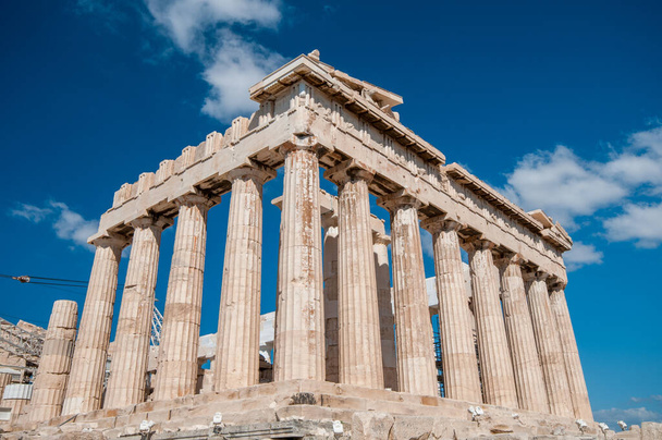 Ancient temple of parthenon with symmetrical columns at acropolis hill in Athens, Greece. Cloudy day, blue sky - Photo, Image