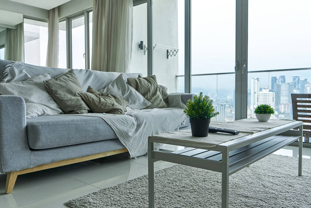 Interior of Living Room Apartments with panoramic windows, on a high floor overlooking the city center. - Photo, image