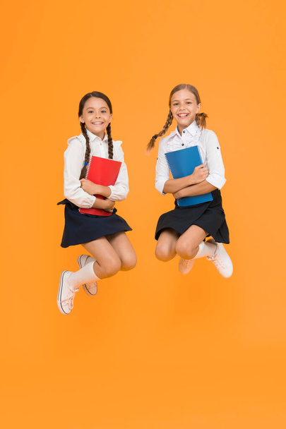 freedom. reading story. childrens literature. cheerful classmates with workbook. dictionary notebook. Get information. little girls in school uniform. kids learning grammar. back to school. - Photo, image