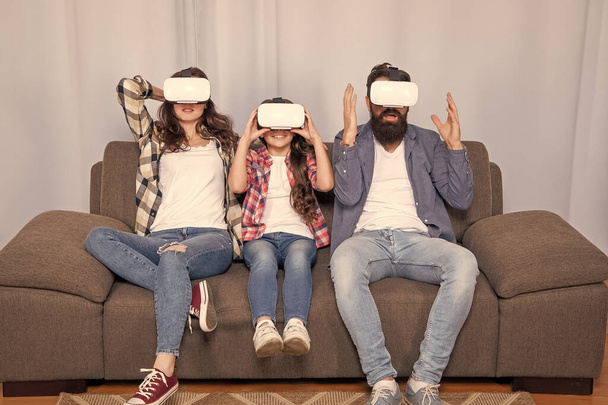 digital future and innovation. modern life. father mother and child wireless VR glasses. virtual reality family. amazed parents with kid girl use modern technology. mom dad and daughter. - Фото, зображення