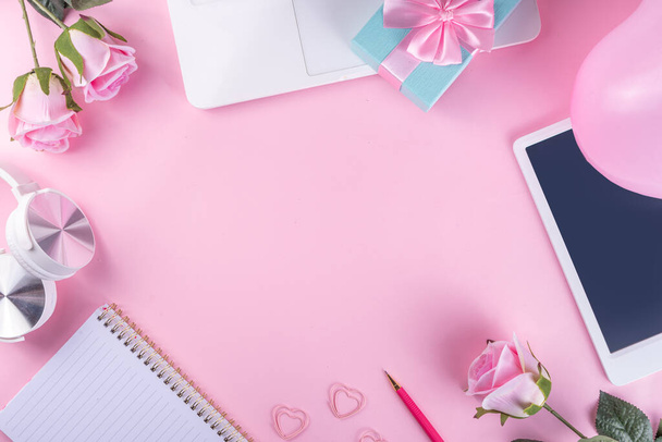 Romantic holiday background. March 8 women's day, valentine's day preparation flatlay with laptop, pink roses flower bouquet, gift box, notepad, sweater, headphnes, on cute pink background copy space - Φωτογραφία, εικόνα