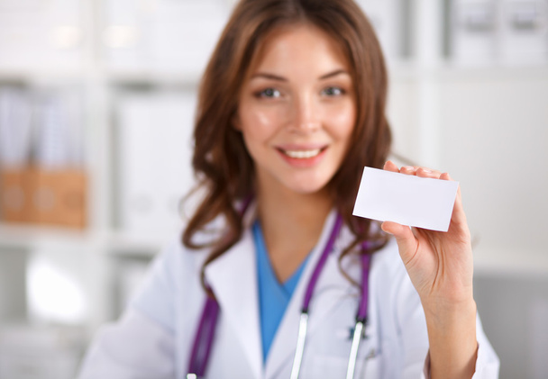 female doctor holding an empty card, isolated on white background - Foto, imagen