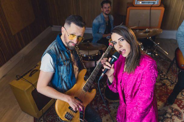Music band with a female singer having a rehearsal in a studio. High quality photo - Photo, Image