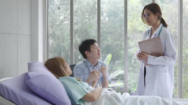 Улыбающаяся азиатка педиатр дать совет пациентам, молодая Азия женщина врач проконсультироваться с пациенткой и обследование в больнице, лечение и концепция помощи - Кадры, видео