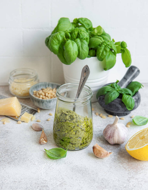 Fresh made Pesto sauce. Green basil pesto.  Ingredient for pesto sauce - Fresh Basil, Pine Nuts, Olive Oil and Cheese - Foto, Imagen