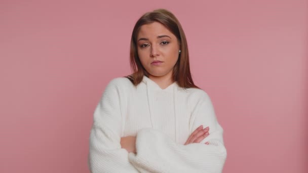 Displeased upset young woman reacting to unpleasant awful idea, dissatisfied with bad quality, wave hand, shake head No, dismiss idea, dont like proposal. Girl isolated alone on pink studio background - Footage, Video