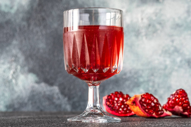 Glass of Pomegranate Daiquiri Cocktail on gray background - Photo, image