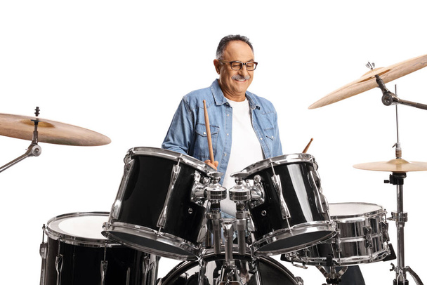 Casual mature man practicing playing drums isolated on white background - Fotó, kép