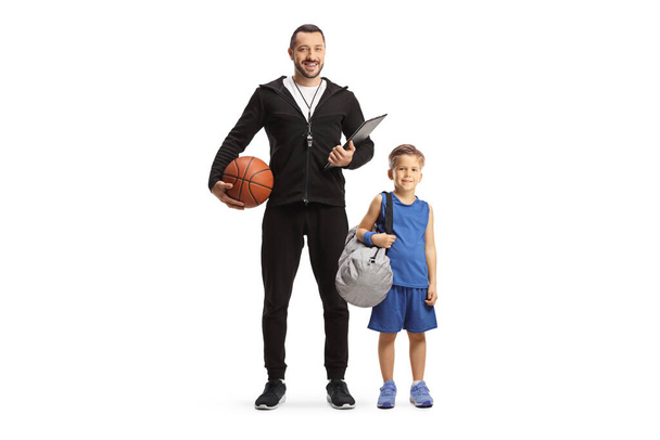Boy carrying a sportsbag and standing with baskeball coach isolated on white backgroun - Fotoğraf, Görsel