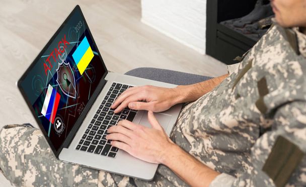 Surveillance and control of opposing information concept, Soldier in camouflage uniform working on laptop for Information Operation. Russia, Ukraine. - Photo, Image