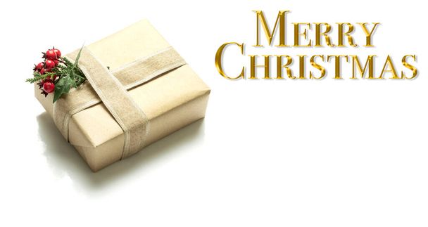 Background with Christmas decoration and gift box. Text in golden letters wishing Merry Christmas. - Foto, immagini